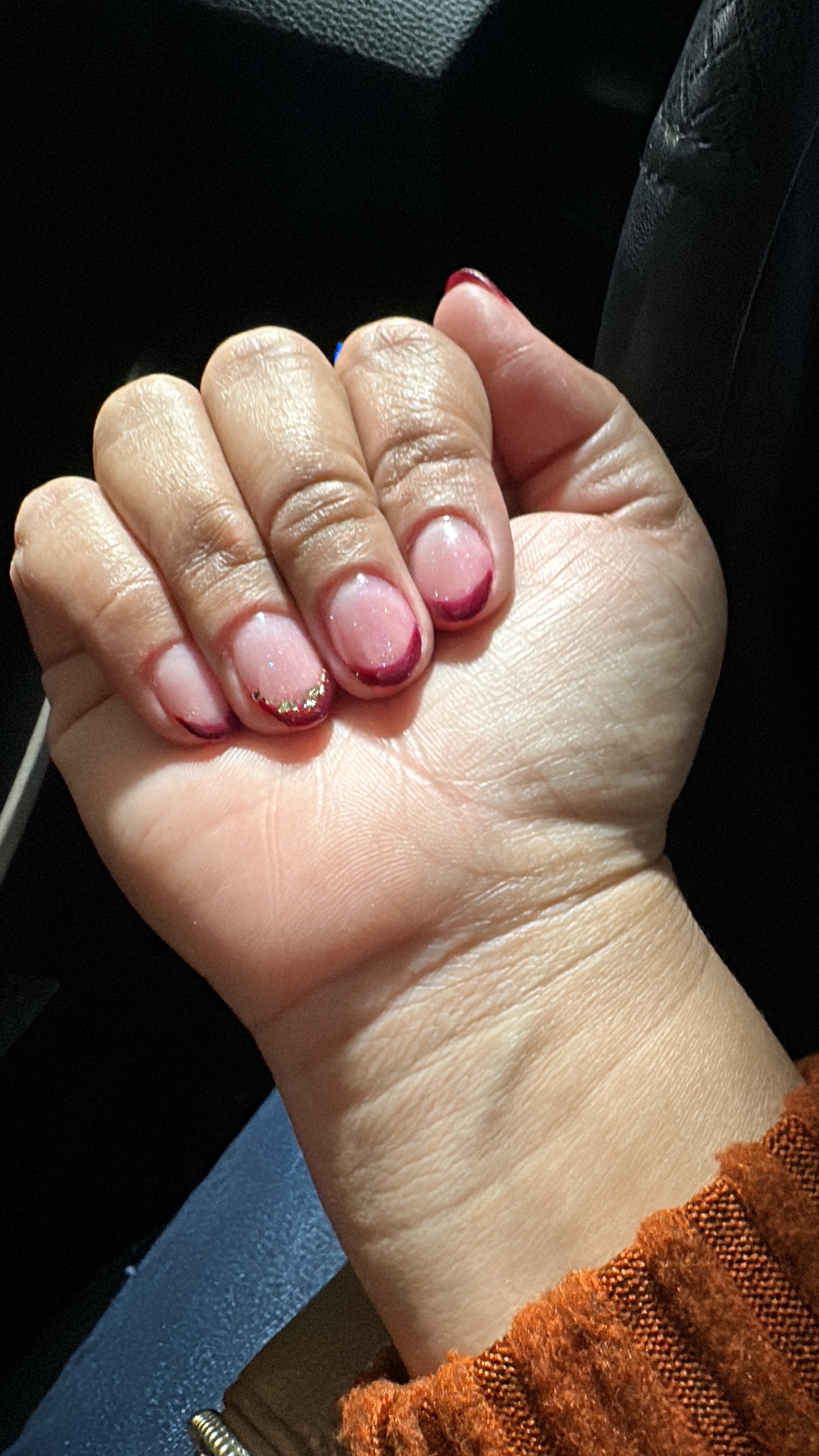 Acrylic french nail manicure with golden flakes.
